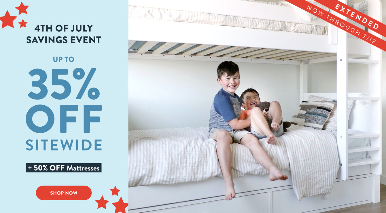 Two boys sitting on the bottom bunk bed laughing with a banner to the left of them which reads "4th of July Savings Event Up to 35% Off Sitewide + 50% Off Mattresses" with a CTA button Below reading "Shop Now"